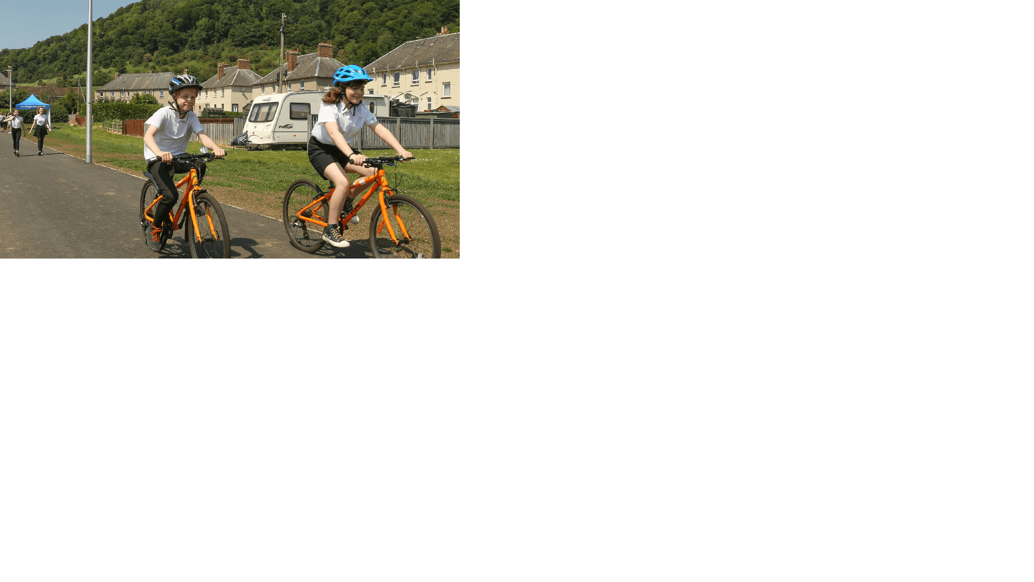 Two school children cycling to school on an active travel multi-use path. Two school children cycling to school on an active travel multi-use path.