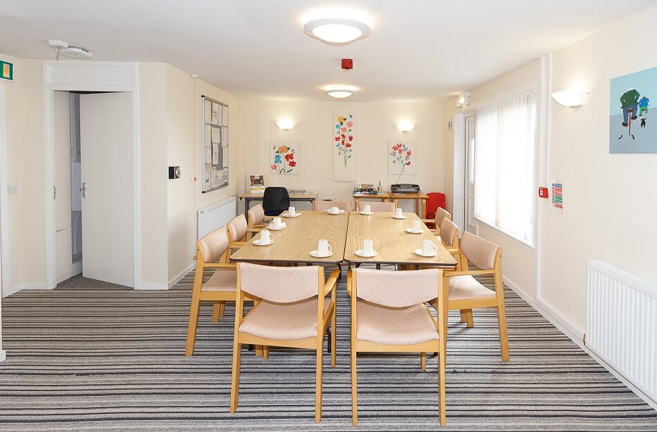 Communal dining area at McFarlane Court, with long table and chairs