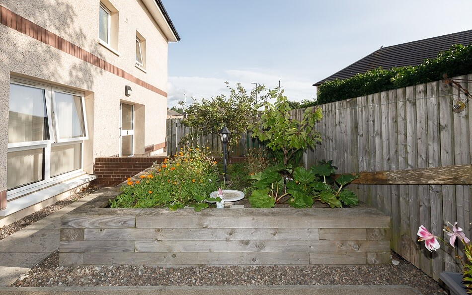 Planter with trees and shrubbery in the communal garden