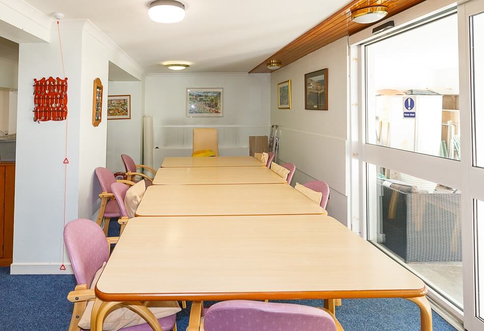 Communal dining area at Bathgate Court, with long table and chairs