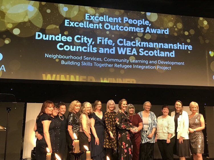 Partnership representatives gathered on stage accepting the Excellent People, Excellent Outcomes award