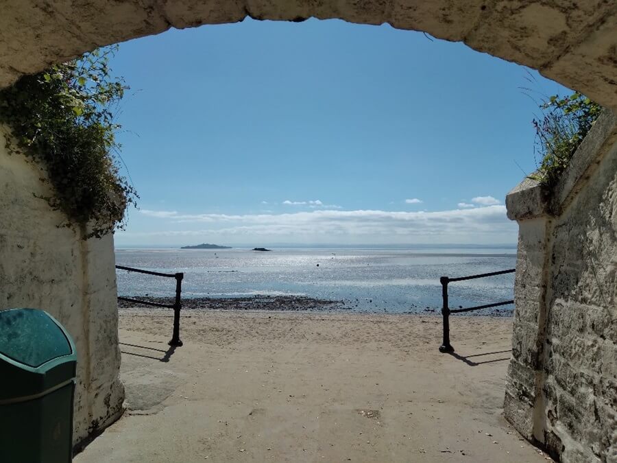 Burntisland links railway underpass showing a sandy beach and water