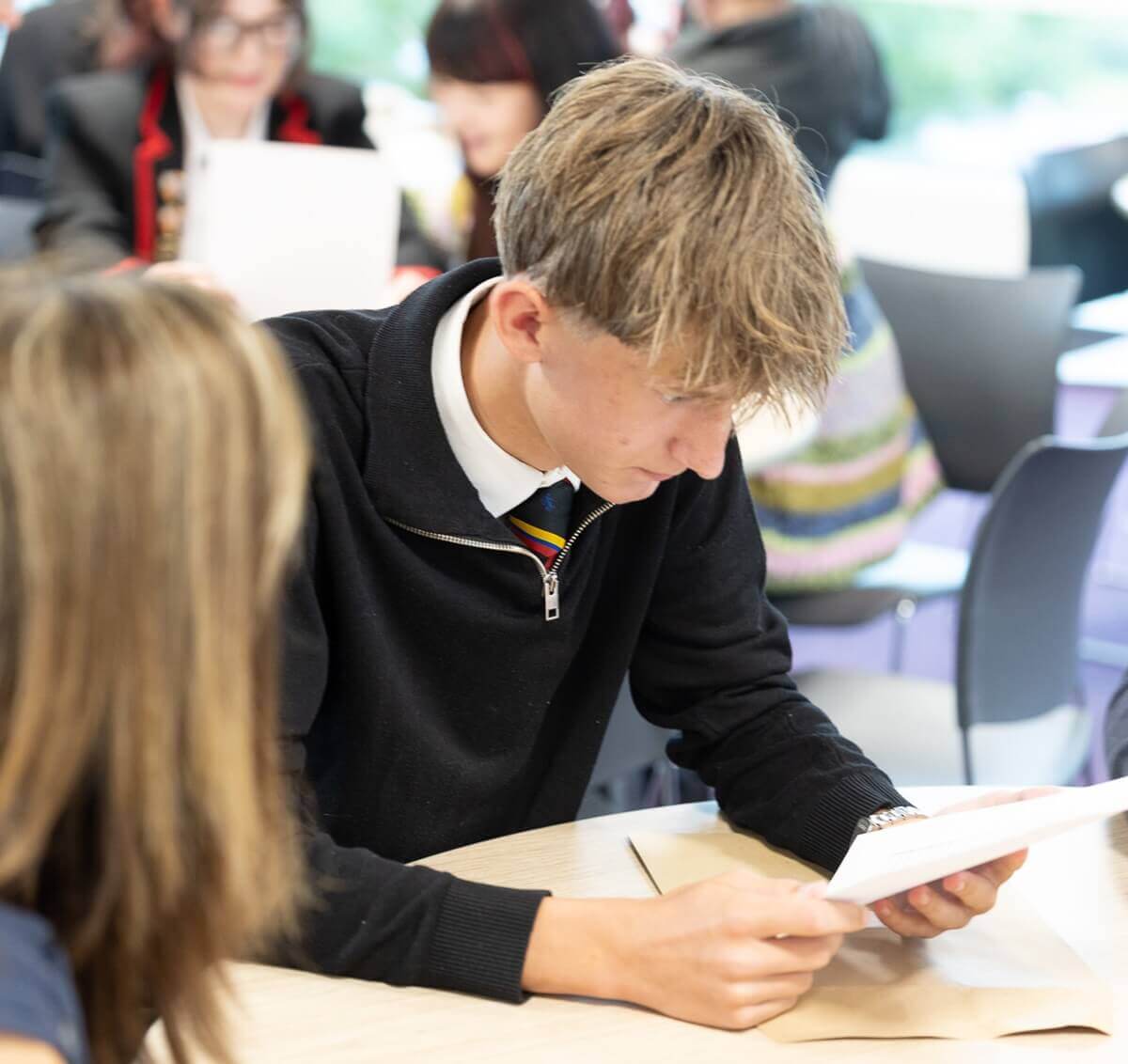 Pupil looks down at exam results paper