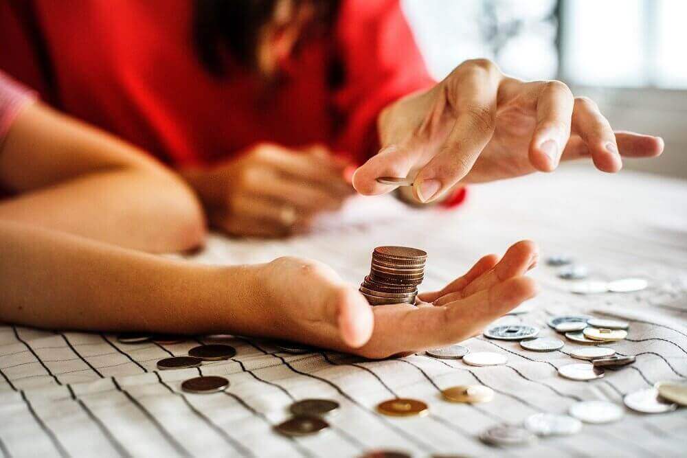 Close up of hands counting up coins