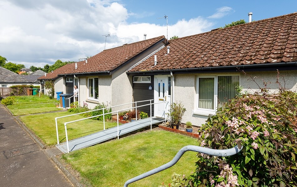 Front of bungalows with grassy gardens to the front at Glebe Road