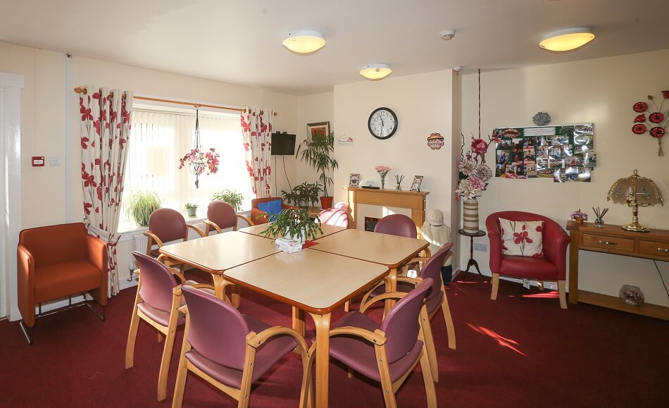 Communal living area at Ross Gardens, with table and chairs