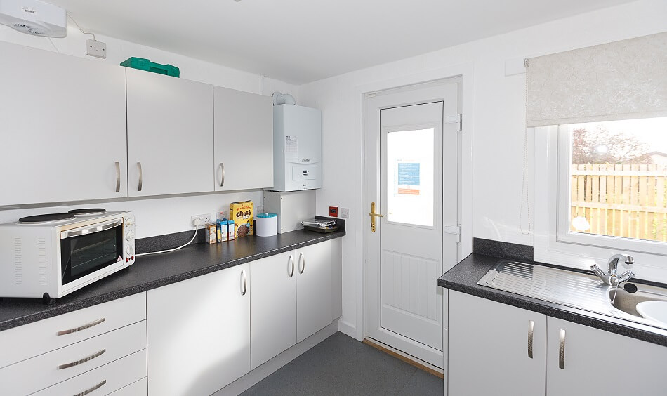 Kitchen with cooking and washing facilities at Sea Road