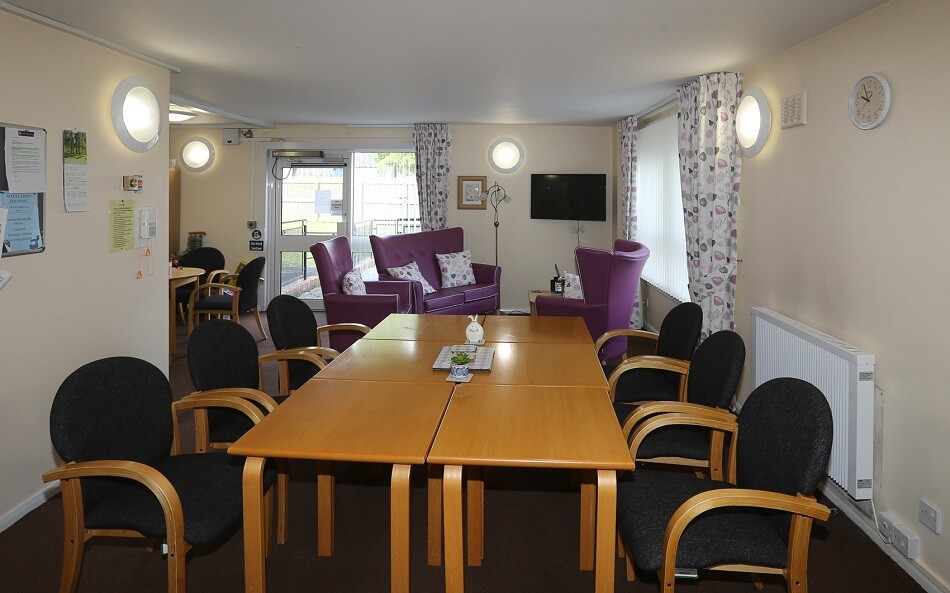Communal dining area at Lismore Place, with large table and six chairs