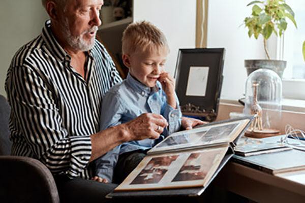 grandparent and child looking at photo album