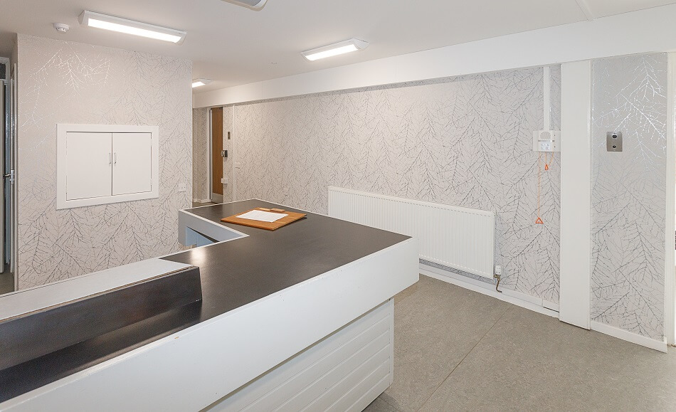 Reception area of Moir Court, with desk and grey and white colour scheme