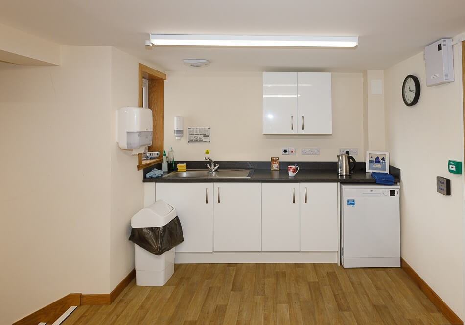 Communal kitchen at Den Court, with sink and tea making area