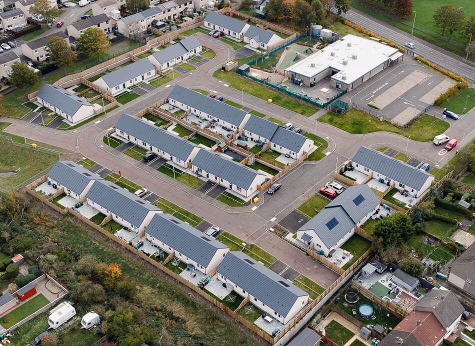 Aerial view of Lathalmond Square, looking down on houses with grey roofs and white facades, with roads and pathways leading to each property