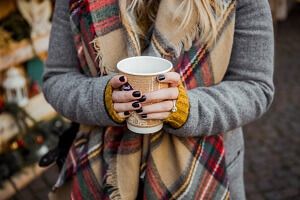 girl holding a cup of hot chocolate