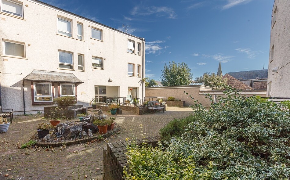 Exterior of Bathgate Court, with seating areas and planters