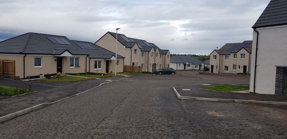 Street view of bungalows and two storey houses, in a new build development