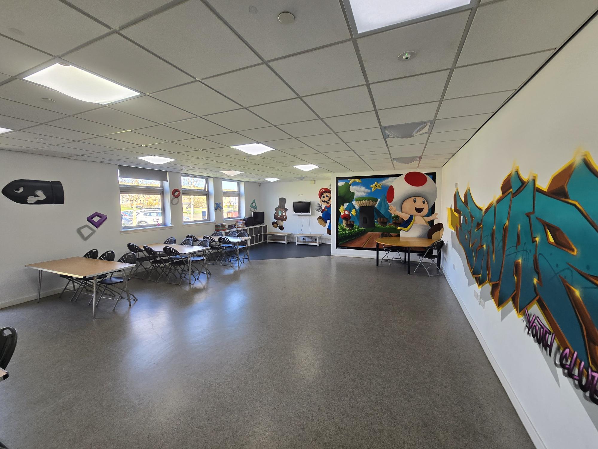 Youth room showing art decor and seating area