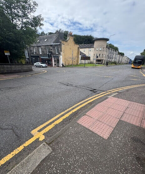 Damaged road surface with cracks at the Carnegie Drive junction in Dunfermline