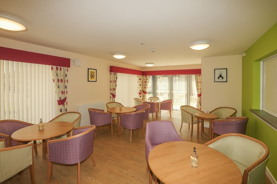 Image of communal seating area with tables, at Napier