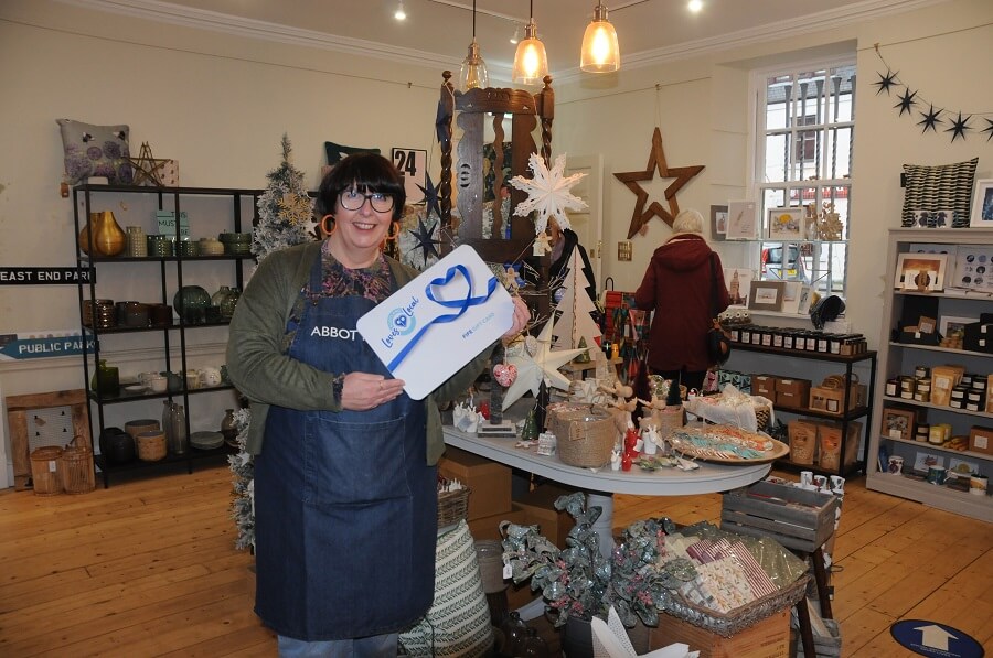 Lousie pictured in her shop with all the Christmas items