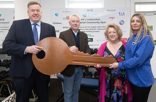 New keys for Templehall Community Gym Line up of people inside the new gym holding a big key