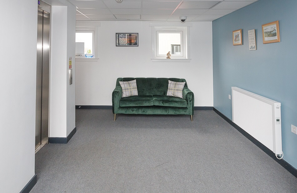 Seating area next to lifts at Den Court