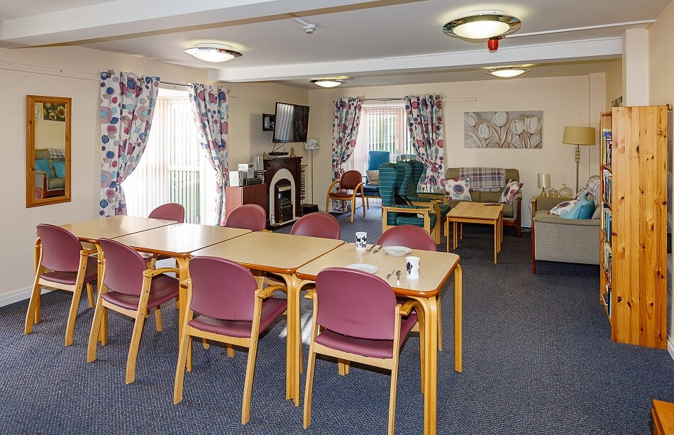 Dining area at Meldrum Court with long table and chairs