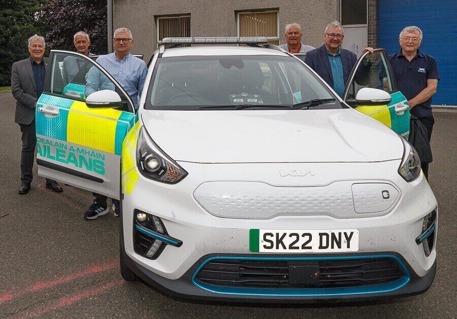 A group of people standing next to an ambulance car - Mental health triage car launched in Levenmouth