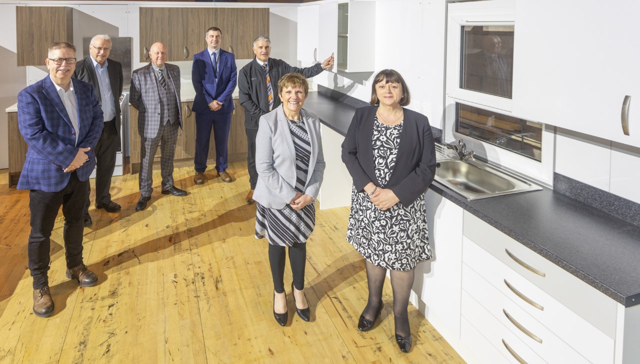Cllr Judy Hamilton standing in a kitchen exhibit with fellow councillors at Fife Council's Better Homes Exhibition - Housing improvements on show at Better Homes exhibition