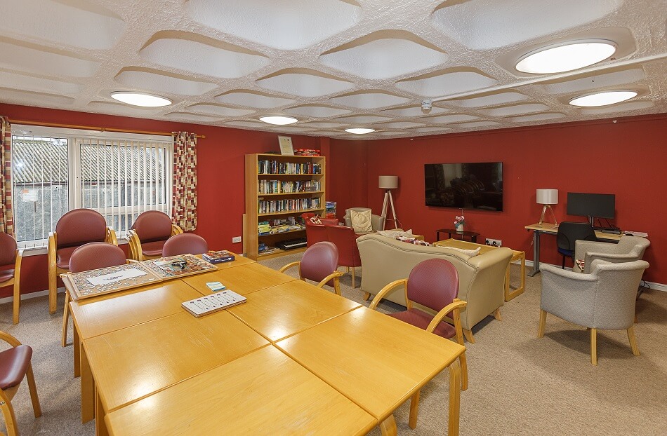 Communal lounge at Allan Court, with large dining table