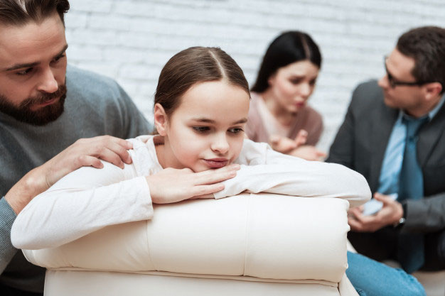 girl being comforted by parent