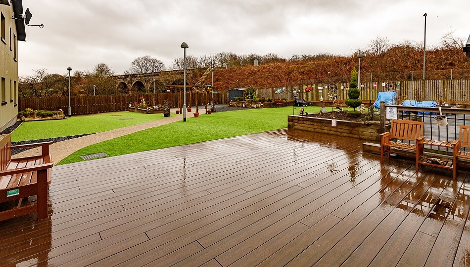 Communal gardens at Den Court, with decking and seating area