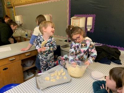 Families enjoying making cookies toghether