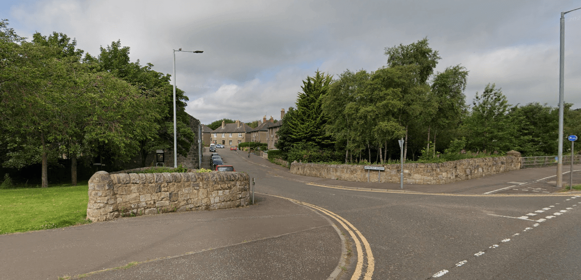 Whirlbut Street showing road, trees and wall at the junction