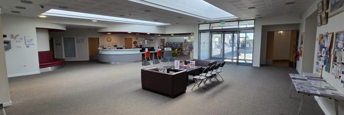 Benarty Centre reception area The spacious reception area of the Benarty Centre, with a curved reception desk, seating area, noticeboards, and large glass entrance doors.
