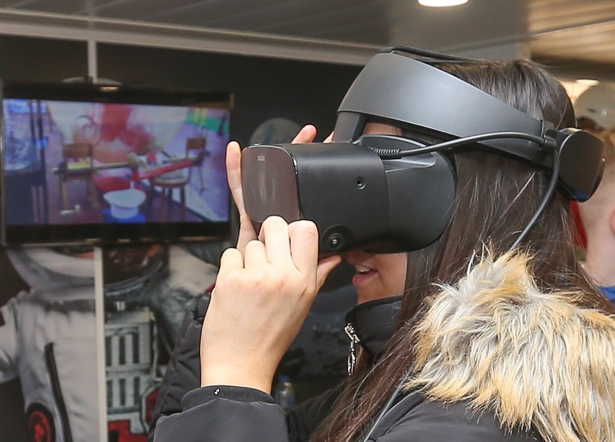 A woman wearing a VR headset - No clash with the Titan