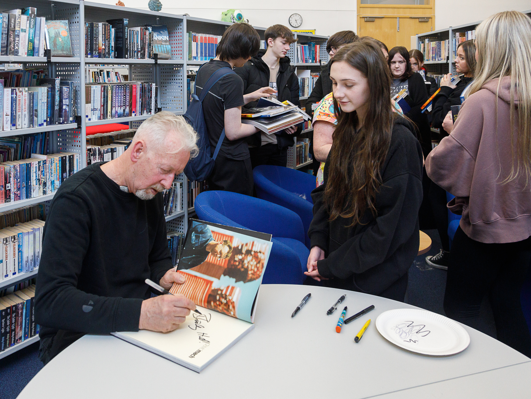 David Mach signs books for pupils at Auchmuty High