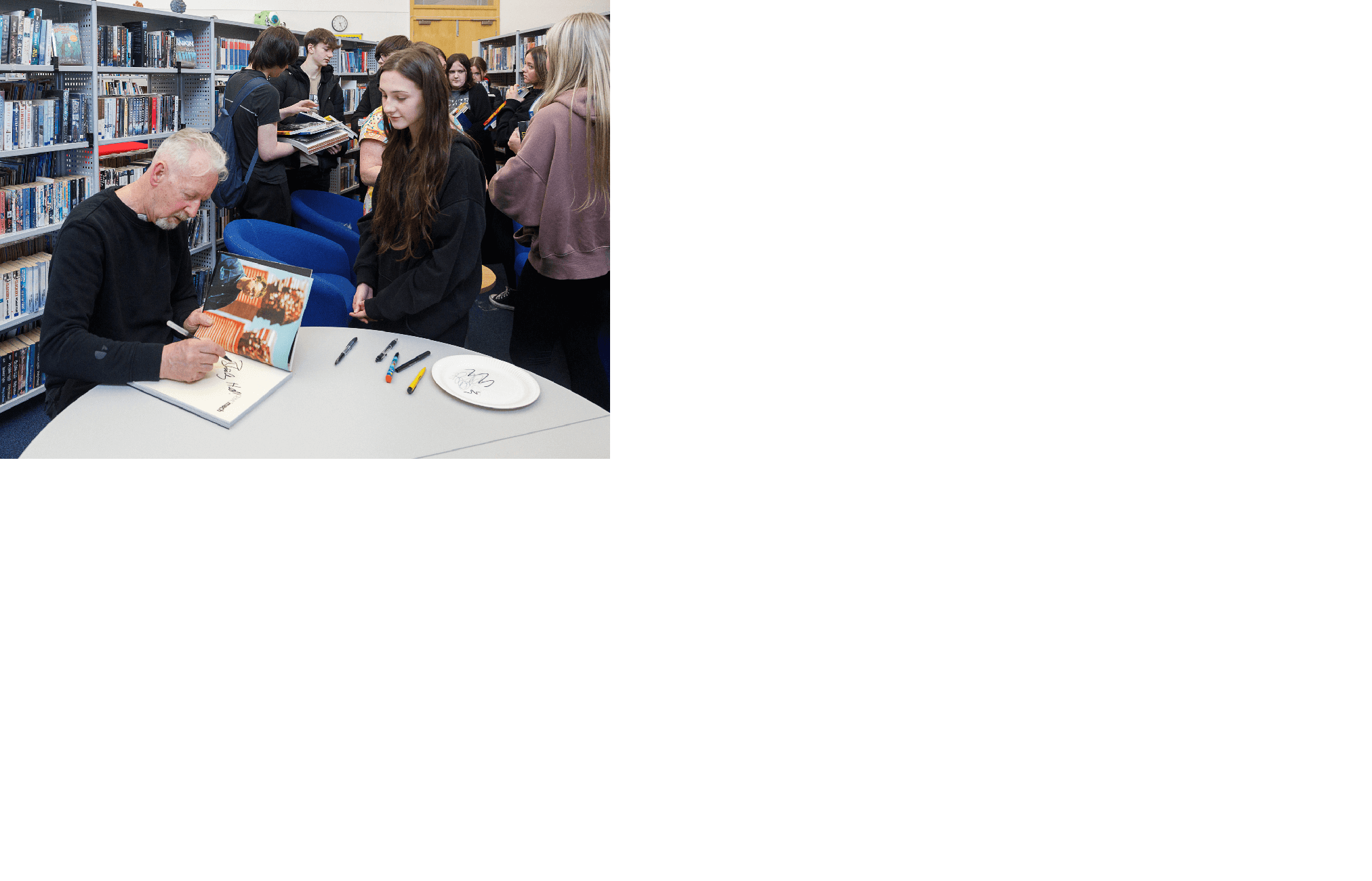 David Mach signs books for pupils at Auchmuty High