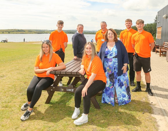 Group of people sitting at a picnic table at the Meedies