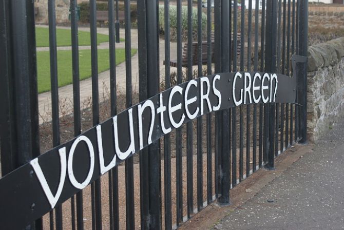 black railings with Volunteers Green in white letters