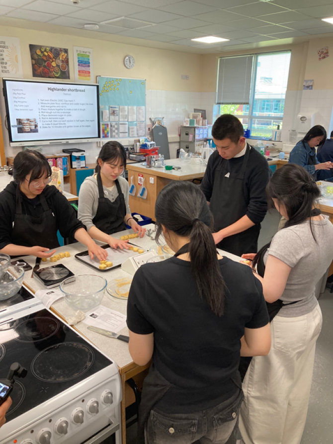 South Korean pupils making traditional Scottish shortbread at Queen Anne High School