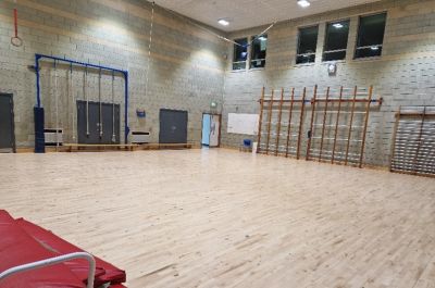 Gymnasium showing open floor and various gymnasium equipment