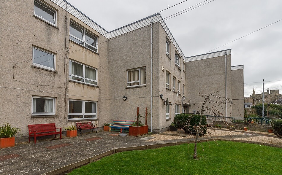 Exterior of Allan Court, with small seating and garden area