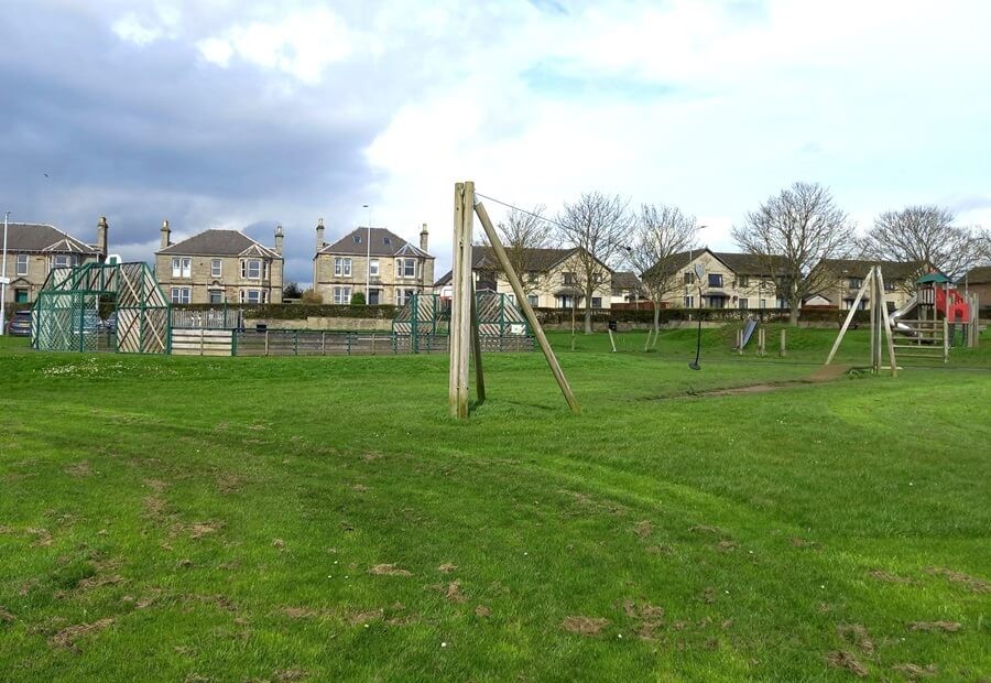 Bankie Park showing play park equipment including zip slide and surrounding grass area