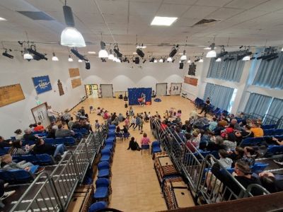 Assembly hall with activity and bleacher seating in use