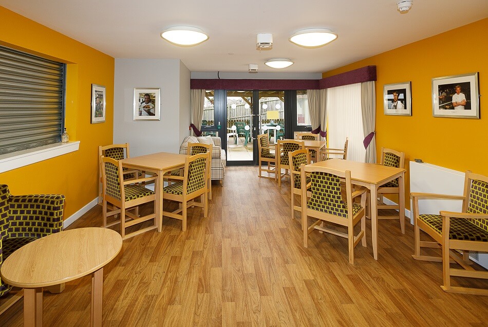 Dining area of Cedar House, with doors leading out to a patio area