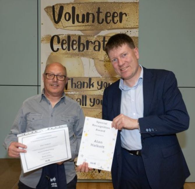 Volunteer receiving award from Councillor