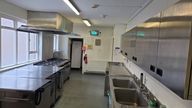 Corn exchange kitchen showing twin sinks, cooker range and cupboards