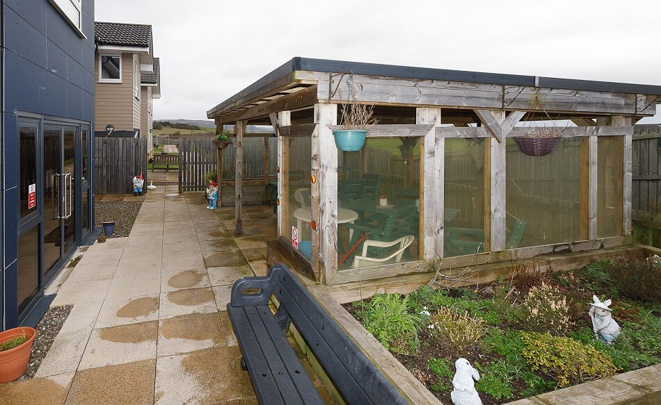 Communal outside space at Cedar House, with undercover seating area and gardens