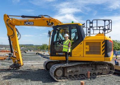 Cllr Judy Hamilton with JCB digger on housing site visit