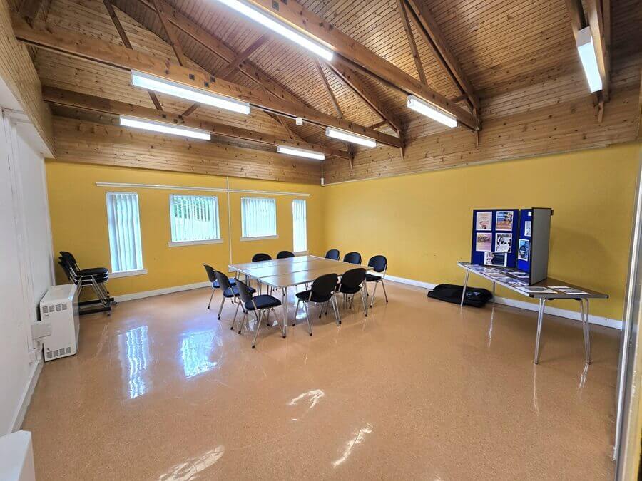 a small room in valleyfield community centre with chairs and tables set-up for meeting